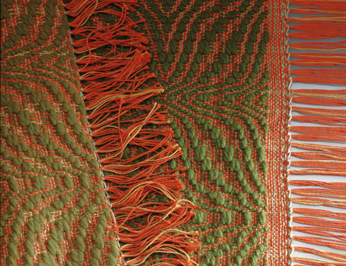 A red and green hand-woven rug